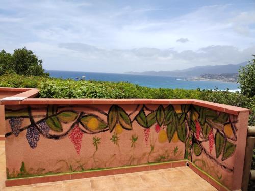 a wall with a painting of fruits on it at MAREVIGLIOSO Fronte Mare Sea Front in Magomadas