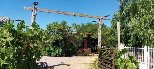 a wooden pergola in front of a house at recanto de pepe 1 in Santa Vitória do Palmar