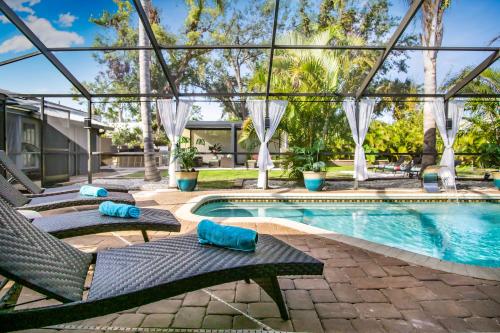 a swimming pool with two lounge chairs and a swimming pool at Heated pool just 1.7 mi to beach The Ocean Pearl in Sarasota