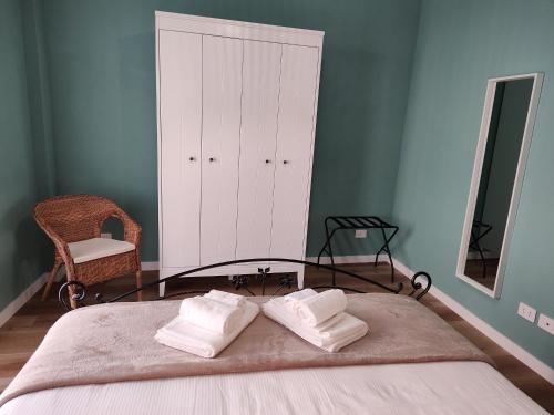 a bedroom with a bed with two towels on it at Civico 34 Urban House in Ciampino