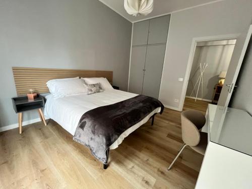 a bedroom with a bed and a table and a chair at Civico 34 Urban House in Ciampino