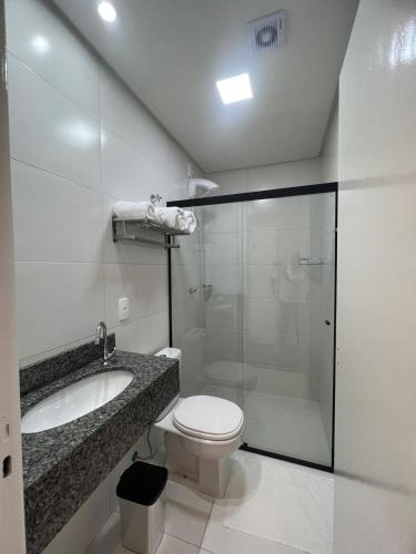a bathroom with a toilet and a sink and a shower at Bortolotti Residence in Penha