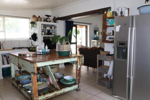 a kitchen with a table and a refrigerator at sonsandsee in Hermanus