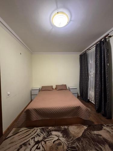 a bedroom with a bed and a light on the ceiling at Готель "Український Дворик" in Lviv