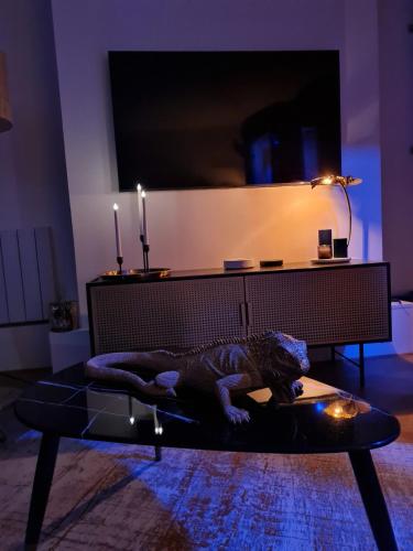 a living room with a table with a dinosaur on it at Spa-Sauna-Ciel de pluie tropicale-Champagne Nuit Romantique - Escapade Mâconnaise in Mâcon