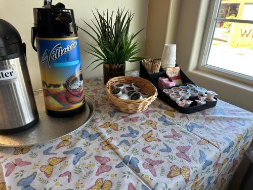 a table with a coffee maker and a bottle of water at Westport Inn Cabins in Westport