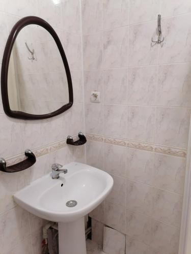 a bathroom with a sink and a mirror at Готель "Український Дворик" in Lviv