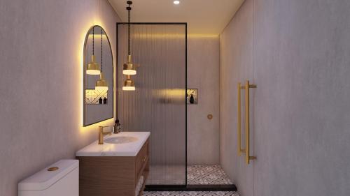 a bathroom with a shower and a sink and a mirror at The Clements Hotel in Cambridge