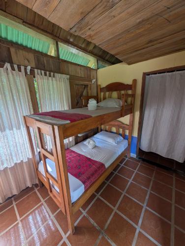 a room with two bunk beds in a house at La Gamba Rainforest Lodge in Golfito