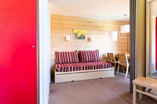 a living room with a couch and a table at Résidence Plagne Lauze - maeva Home - Studio 4 Personnes - Sélection MAE-4434 in Mâcot La Plagne