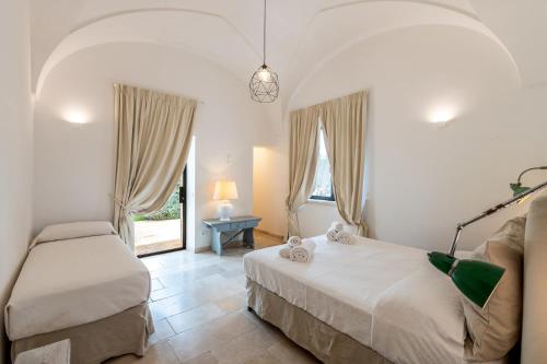 Postel nebo postele na pokoji v ubytování Trulli di Mezza