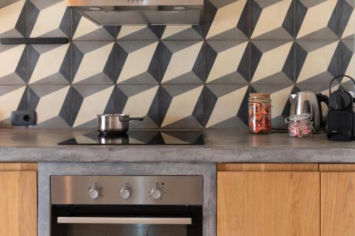 a kitchen with a stove and a counter top at Trulli di Mezza in Cisternino