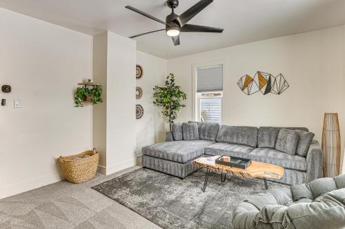 a living room with a gray couch and a table at 3 Mi to Downtown Youngstown Updated Apartment in Youngstown