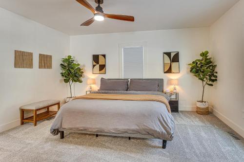 a bedroom with a bed and two potted plants at 3 Mi to Downtown Youngstown Updated Apartment in Youngstown