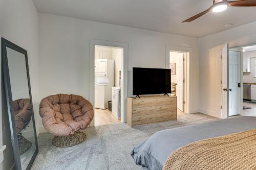 a bedroom with a bed and a flat screen tv at 3 Mi to Downtown Youngstown Updated Apartment in Youngstown