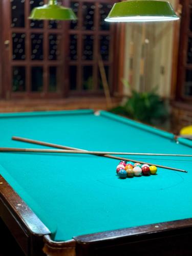 a pool table with cue balls on it at Re-Canto dos Pássaros - Mendes in Mendes