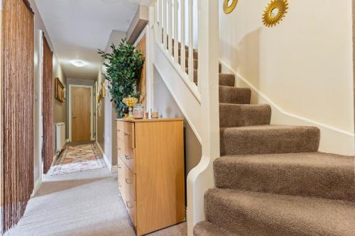 a home hallway with stairs and a dresser at Desi Suite, Free Parking, Balcony in Leicester