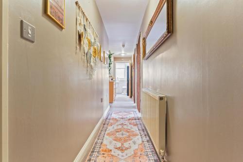 a hallway with a rug on the floor at Desi Suite, Free Parking, Balcony in Leicester