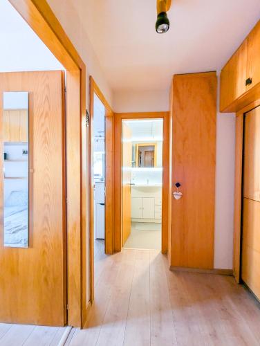 an empty hallway with a door and a kitchen at Cosy Centered with Garden and View in Veysonnaz in Veysonnaz