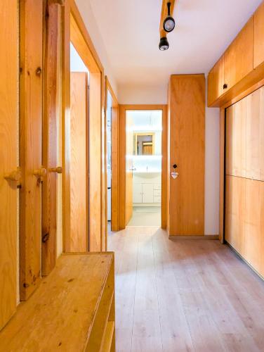 a hallway of a house with wooden walls and a door at Cosy Centered with Garden and View in Veysonnaz in Veysonnaz