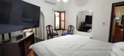 a bedroom with a bed and a large mirror at Camunda in Punta del Este
