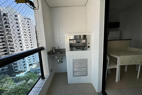 a small bathroom with a sink and a sink at Paraíso com piscina: Pitangueiras Lazer Completo in Guarujá
