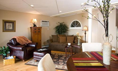 a living room with a couch and a table at Sands By The Sea Motel in York Beach