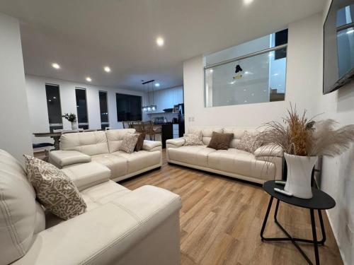 a living room with two white couches and a table at Casa de Playa - Asia - SELENE beach house in Asia