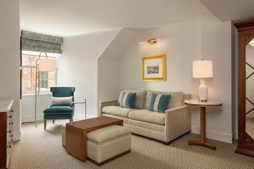 a living room with a couch and a chair at Hotel Roanoke & Conference Center, Curio Collection by Hilton in Roanoke