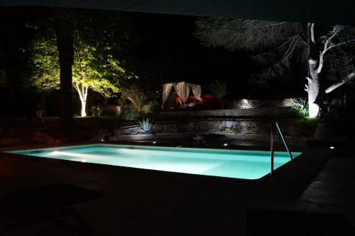 a swimming pool in a yard at night at Chambre d'hôtes Clos du Petit Jésus in Cassis