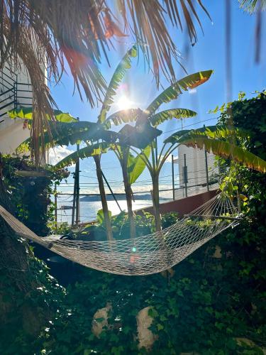 a hammock with the beach in the background at Casa Klod Ibiza in Ibiza Town