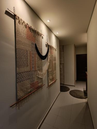 a hallway with paintings on the wall of a room at GREEN GARDEN APARTMENT IN ODIVELAS in Odivelas