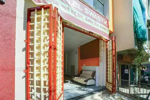 an open door of a building with a couch inside at Hotel O Swastik in Bhopal