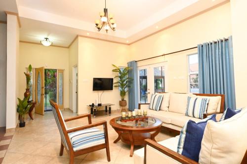 a living room with a couch and a table at Iyanola Tee Joys Villa in Gros Islet