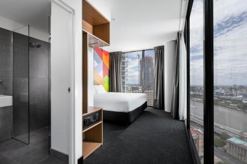 
a large white bathroom with a large window at ibis Styles Brisbane Elizabeth Street in Brisbane
