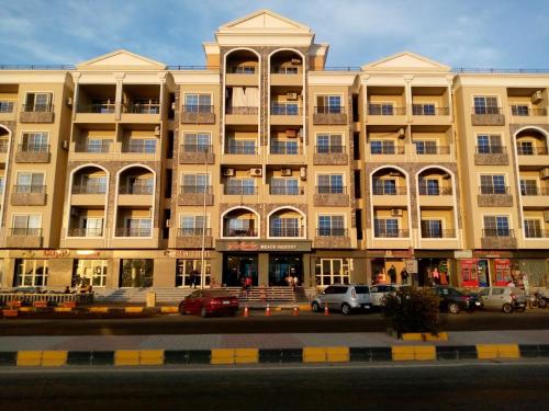 a large building with cars parked in front of it at الغردقه in Hurghada
