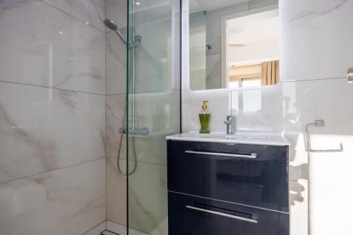 a bathroom with a sink and a shower at Villa Stella Sunset in Nea Dimmata