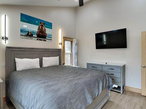 a bedroom with a bed and a flat screen tv at Majestic Manor in McHenry