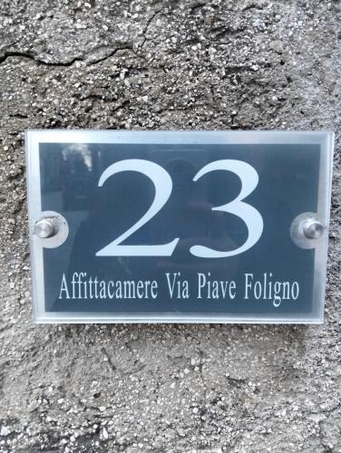 a sign on the side of a road with at Affitta camere Via Piave in Foligno