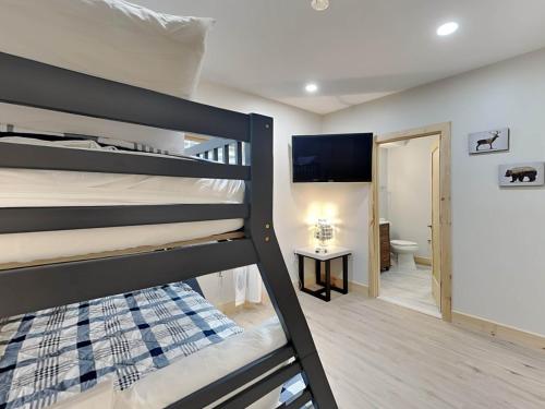 a bedroom with two bunk beds and a bathroom at Majestic Manor in McHenry