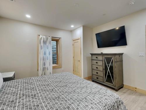 a bedroom with a bed and a television on the wall at Majestic Manor in McHenry