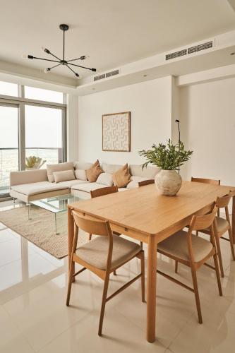 a living room with a table and a couch at Paramount - Luxury 2BR Apartments with Burj or Sea Views - Access to the Infinity Pool on 64th Floor in Dubai