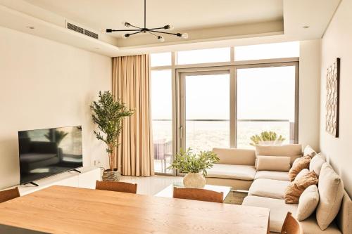 a living room with a couch and a table at Paramount - Luxury 2BR Apartments with Burj or Sea Views - Access to the Infinity Pool on 64th Floor in Dubai