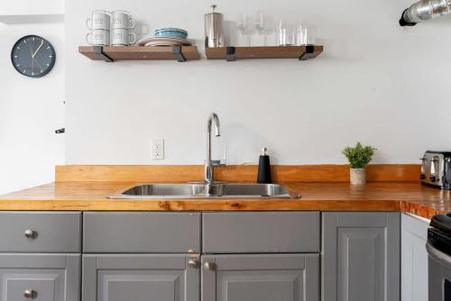a kitchen with a sink and a wooden counter top at Private 2 Storey Home with 3BR-2BA by Queen West in Toronto