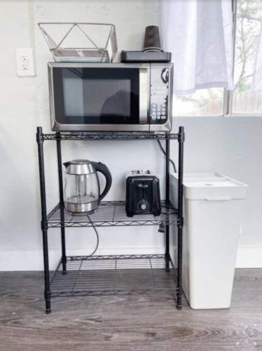 a microwave sitting on a shelf with a camera at Nifty Trailer With Spacious Parking in Visalia