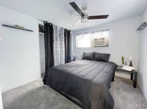a bedroom with a bed and a ceiling fan at Nifty Trailer With Spacious Parking in Visalia