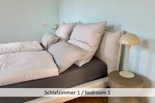 a couch with pillows on it in a room at Neue90 - Fewo Saumagen, Weinstraße Kallstadt Pfalz in Kallstadt
