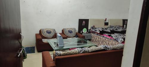 a table sitting on top of a couch with pillows at Kumar House in Prayagraj