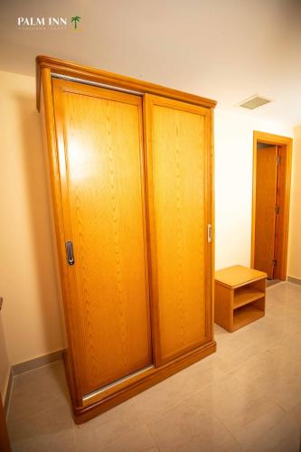 a room with two wooden lockers in a room at Palm Inn Hotel Hurghda in Hurghada
