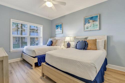 a bedroom with two beds and a ceiling fan at Near Beach & Coligny Plaza, Pool, Hot Tub, Patio in Hilton Head Island